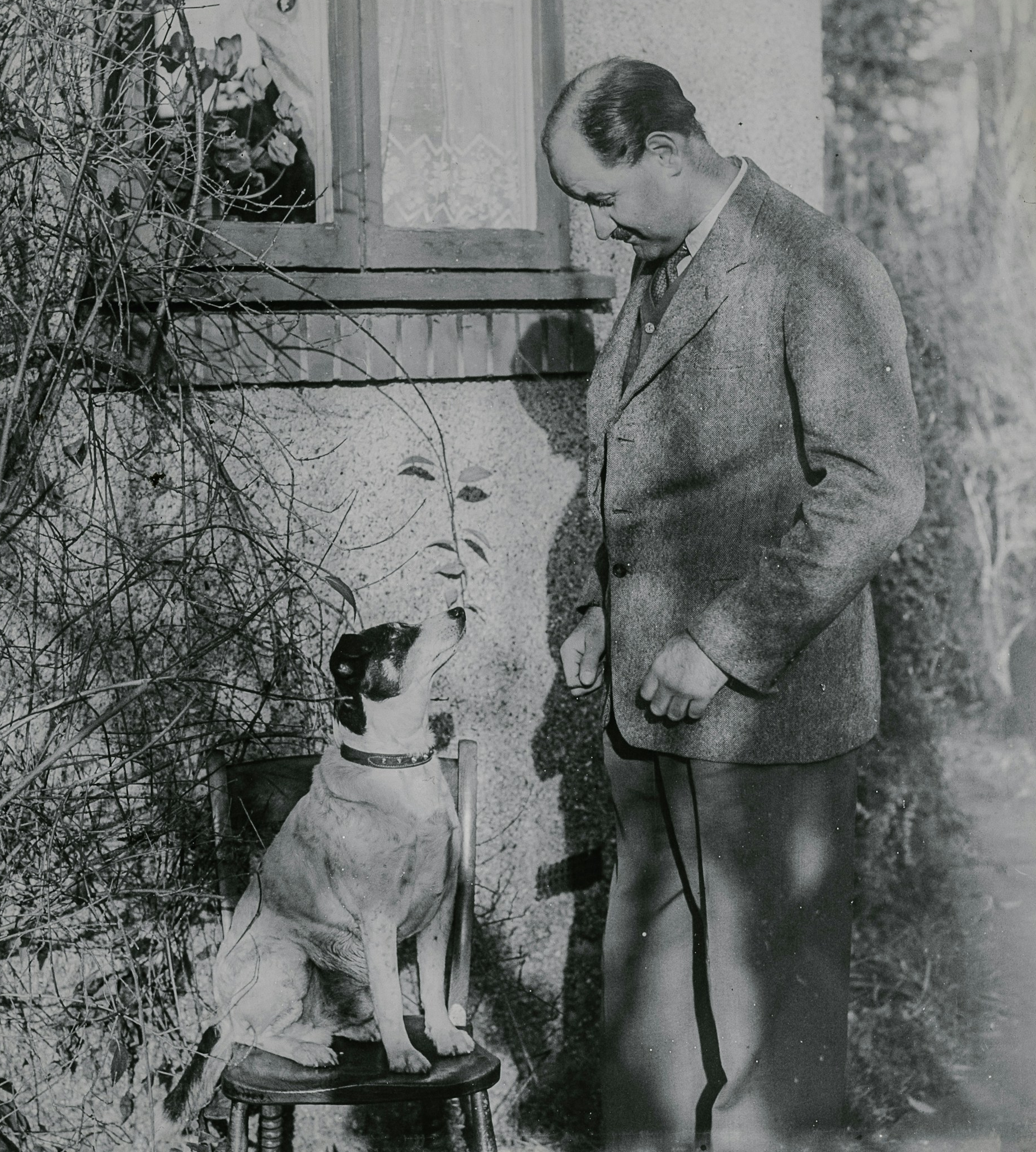 vintage photograph of a dog and a man